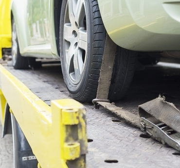 car-transporter-breakdown-lorry-working-using-locked-belt-transport-other-green-car (1) (1) car transporter breakdown lorry during working using locked belt transport other green car for repairing at car center in a bangkok city thailand